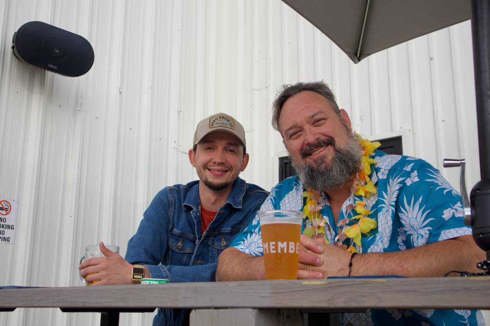 Two makers enjoying beers together at a Tall Pine Events market